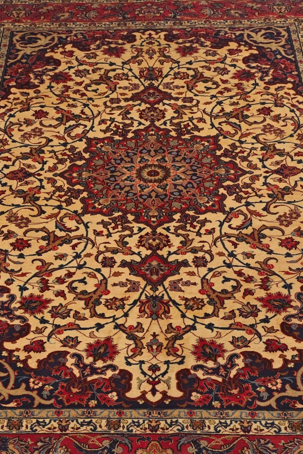 Arabesque medallion detail in gold and red on Sirafian Isfahan rug