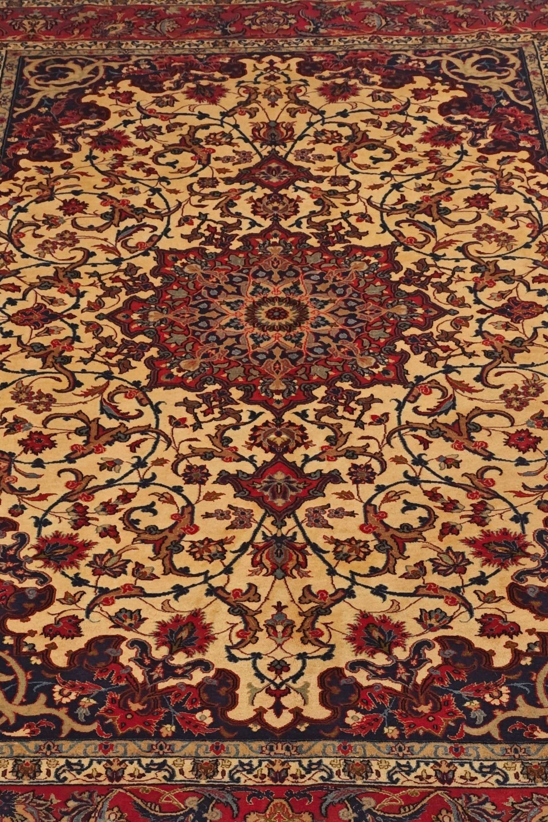 Arabesque medallion detail in gold and red on Sirafian Isfahan rug