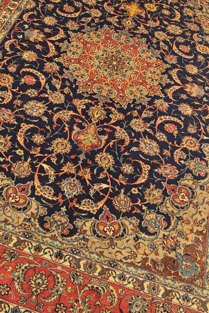 Arabesque medallion detail in indigo and terracotta on Sirafian Isfahan rug