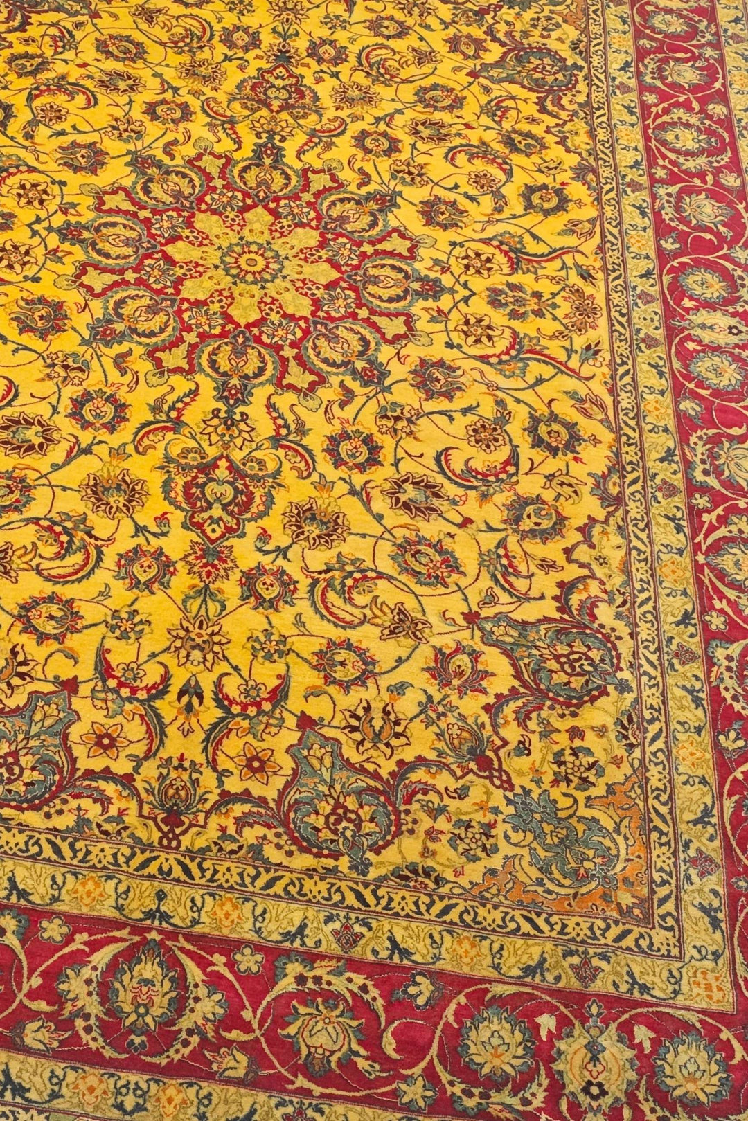 Star medallion detail in gold and crimson on Isfahan rug