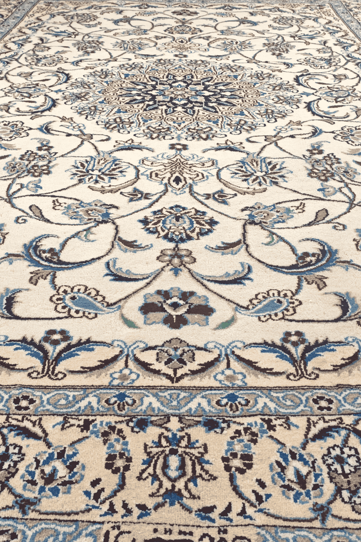 Fringe of ivory and blue floral Persian Nain rug
