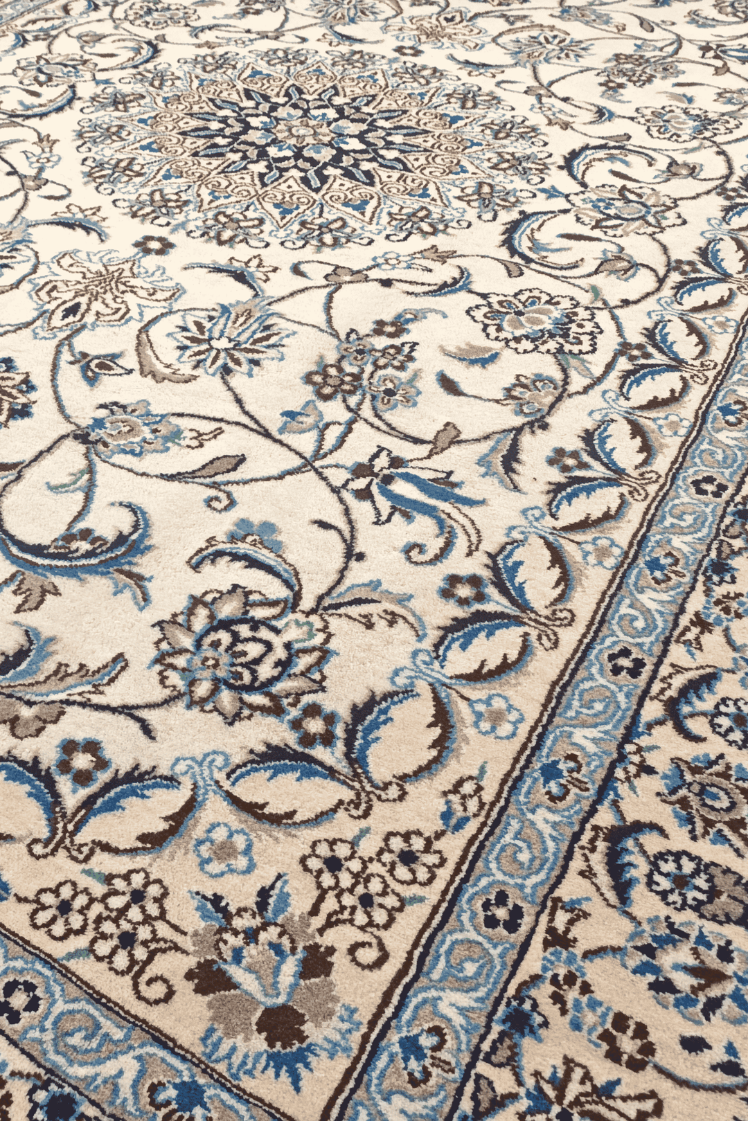 Border detail of ivory blue floral Nain rug