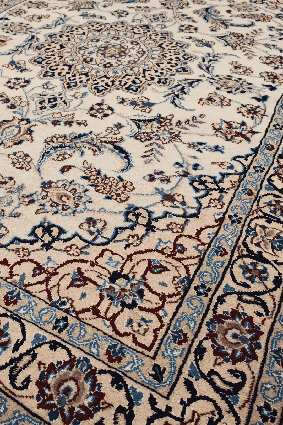 Border detail of ivory Nain hand-knotted rug