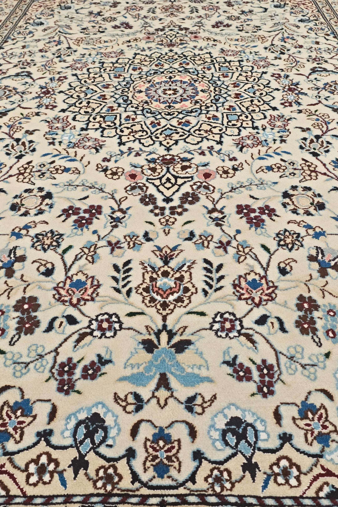 Corner of ivory wine Nain hand-knotted rug