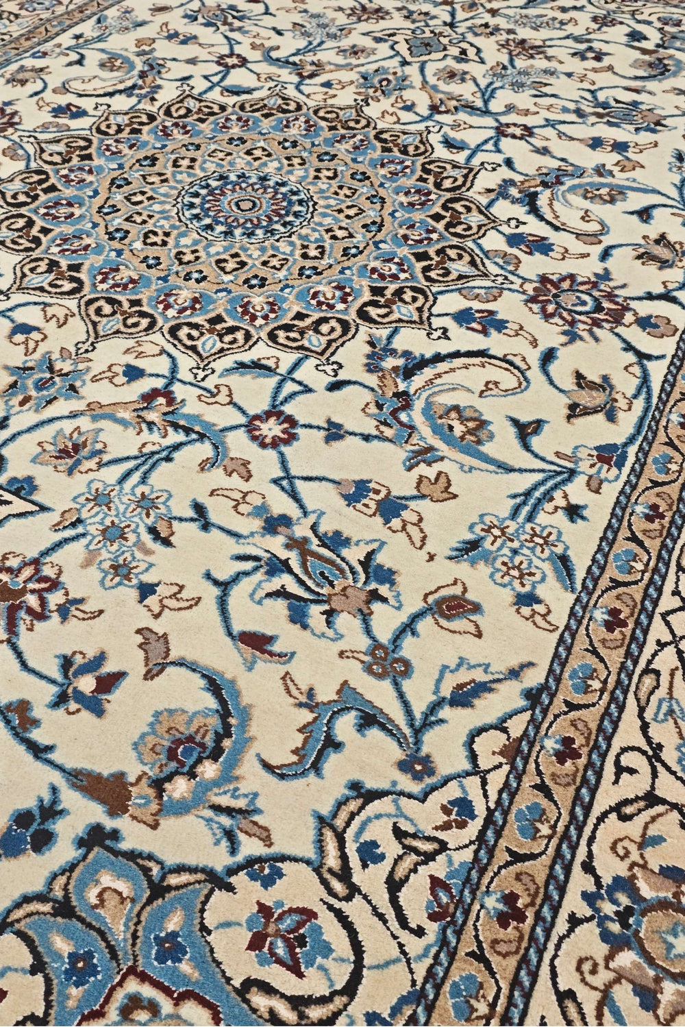 Medallion detail in ivory and sky blue on Persian Nain rug