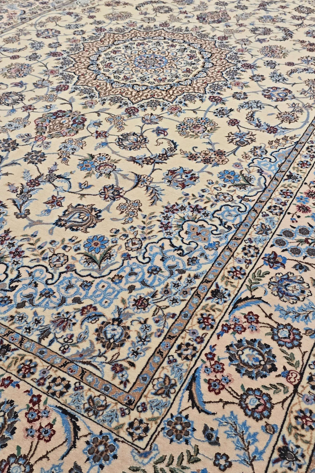Medallion detail in sandstone and blue on Persian Nain rug
