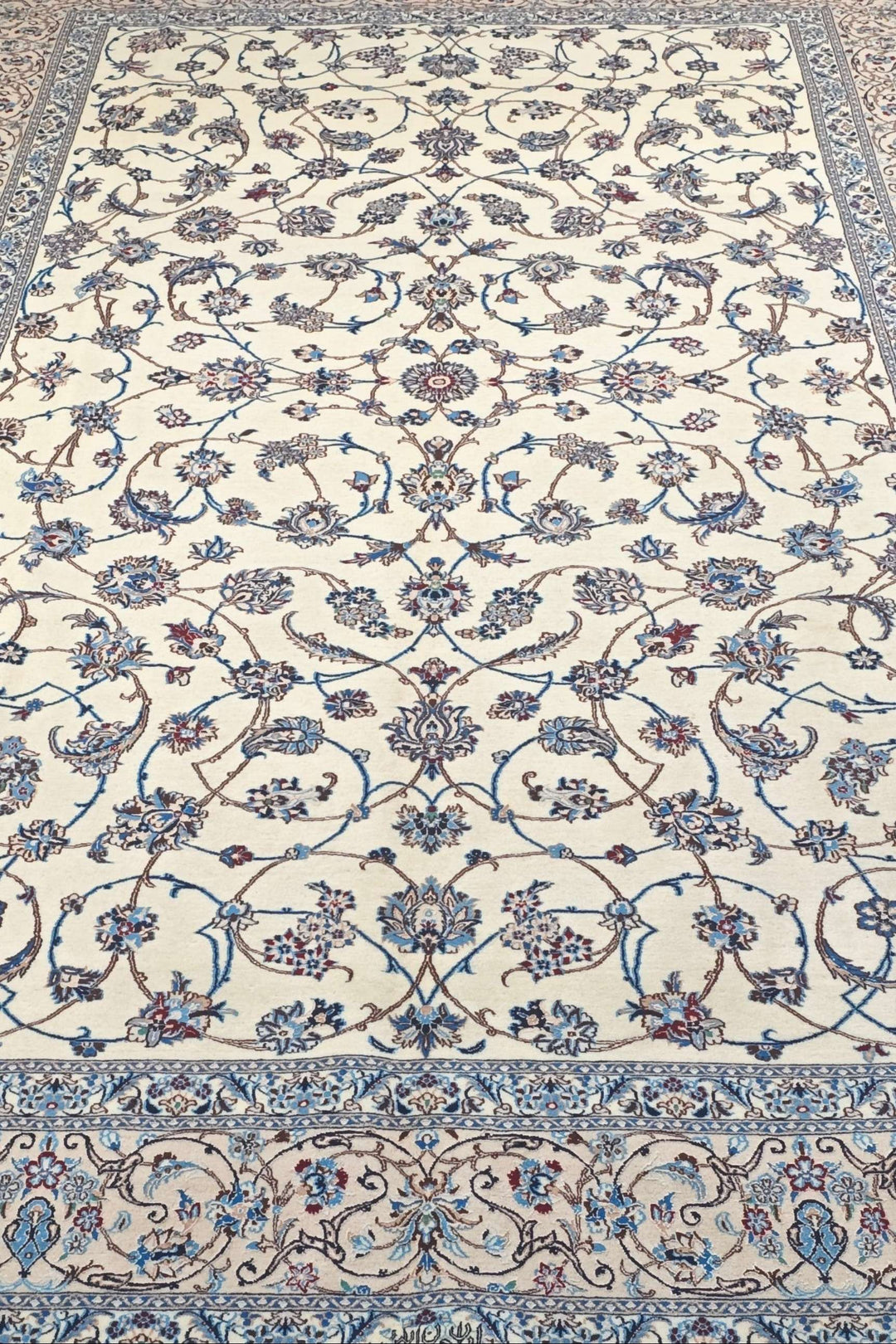 Fringe of ivory and blue arabesque Persian Nain rug