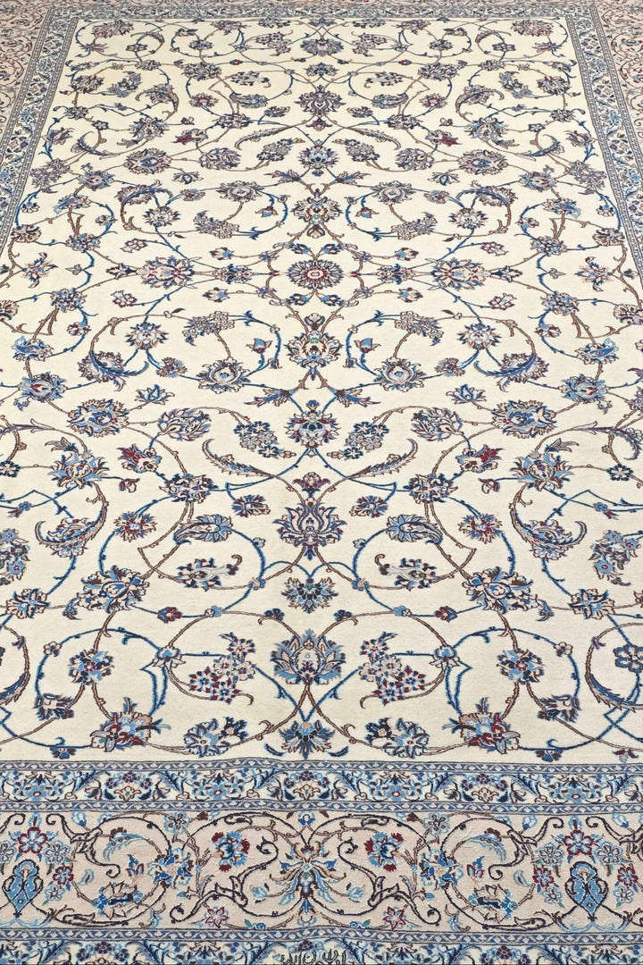 Fringe of ivory and blue arabesque Persian Nain rug
