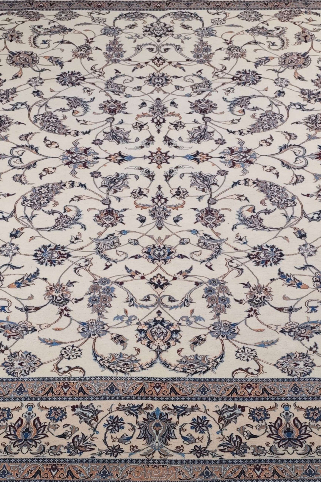 Border detail of ivory salmon arabesque Nain rug