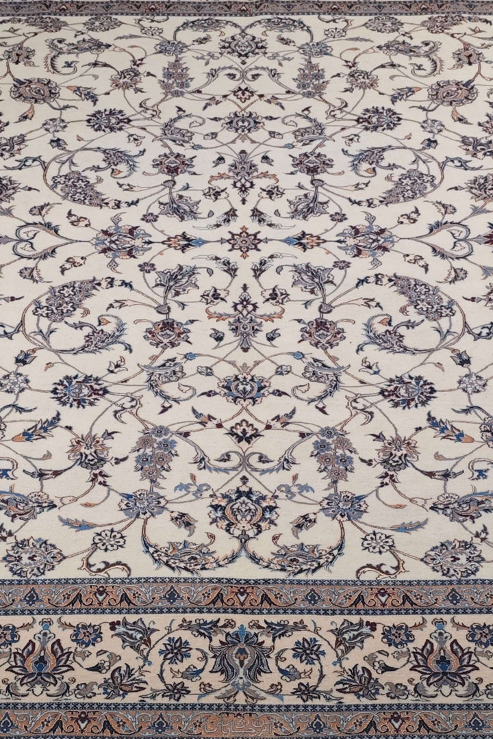 Border detail of ivory salmon arabesque Nain rug