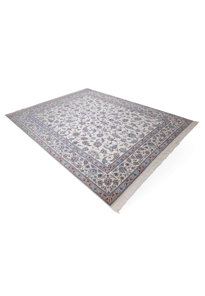 Corner of ivory salmon arabesque Nain rug