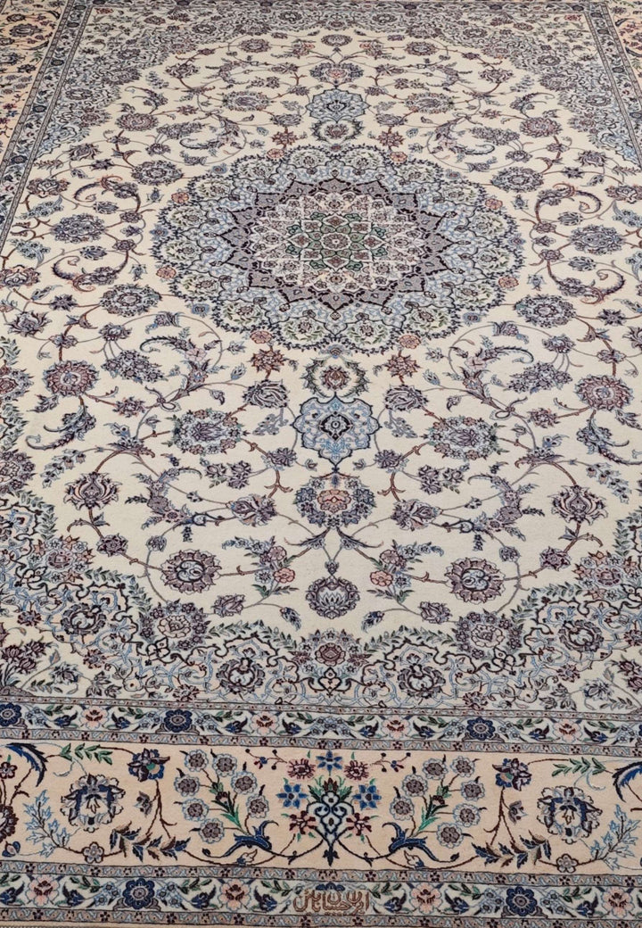 Border detail with woven birds on ivory blue Nain rug