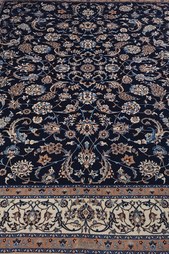 Border detail of navy ivory arabesque Nain rug