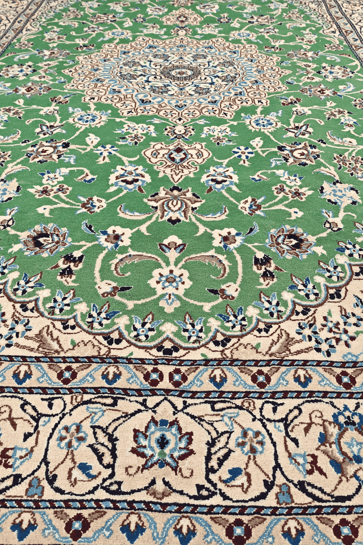 Corner of pistachio green Nain hand-knotted rug