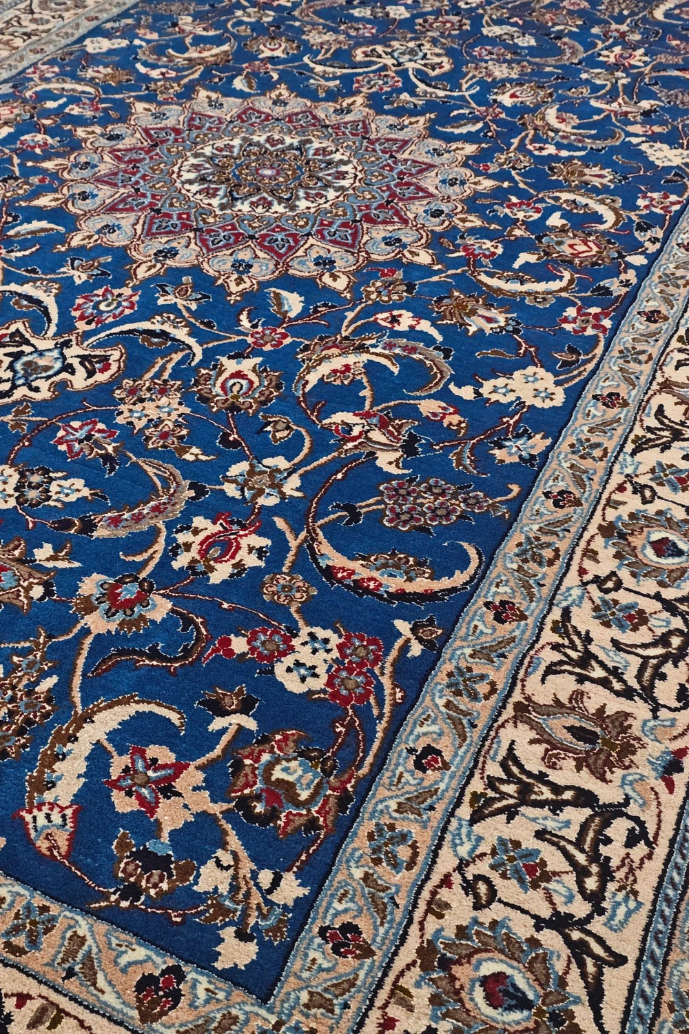 Medallion detail in cobalt blue and ivory on Persian Nain rug