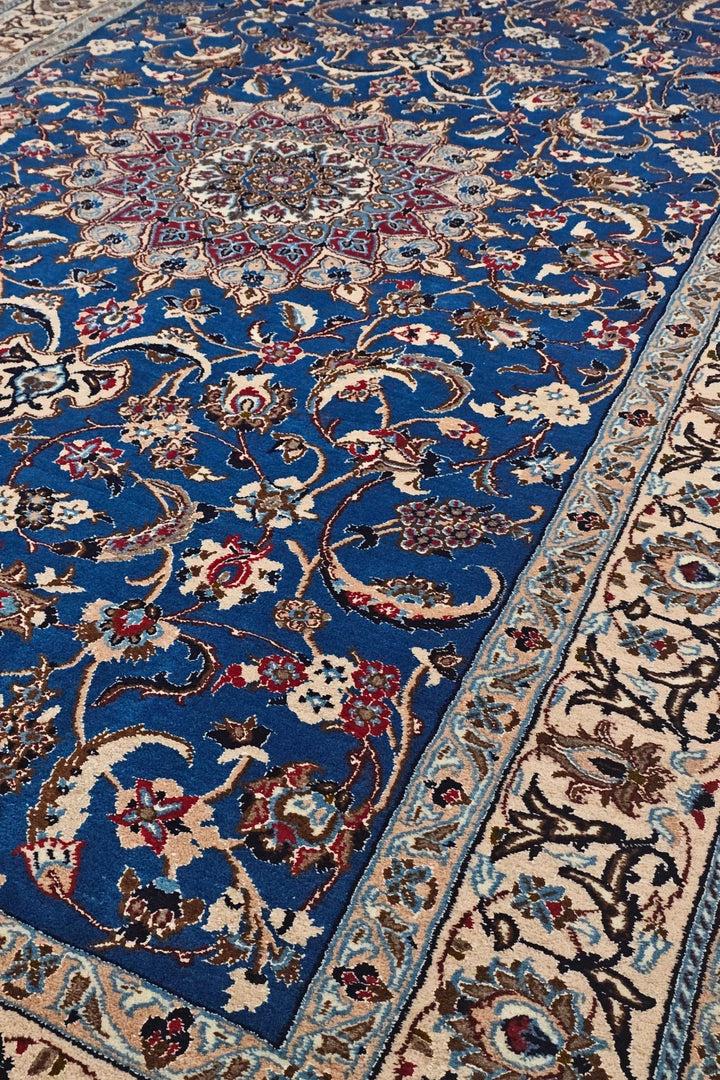 Medallion detail in cobalt blue and ivory on Persian Nain rug