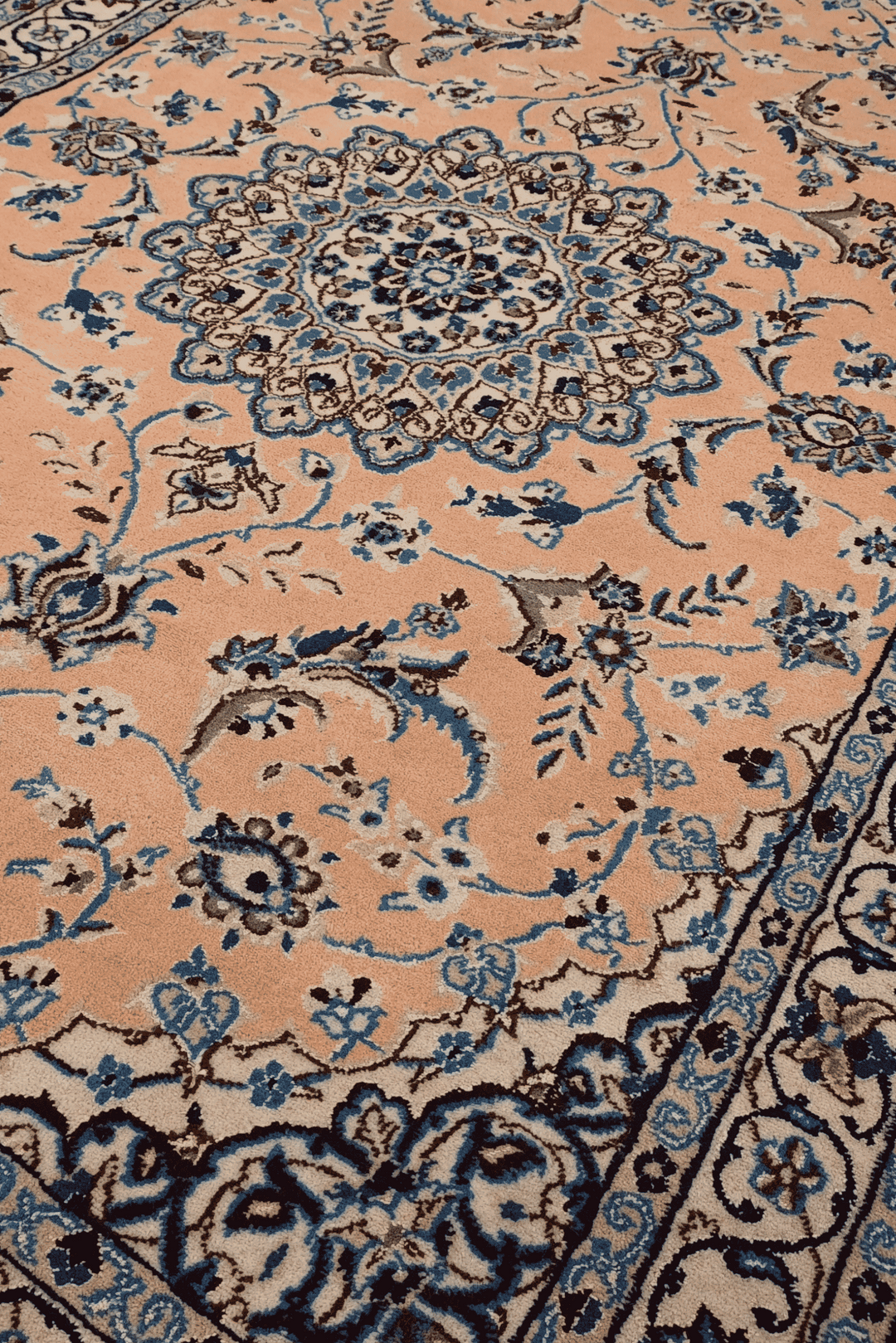 Border detail of peach Nain hand-knotted rug