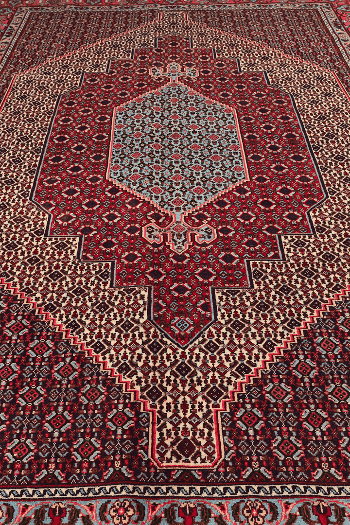 Corner of red Herati Sabzevar hand-knotted rug