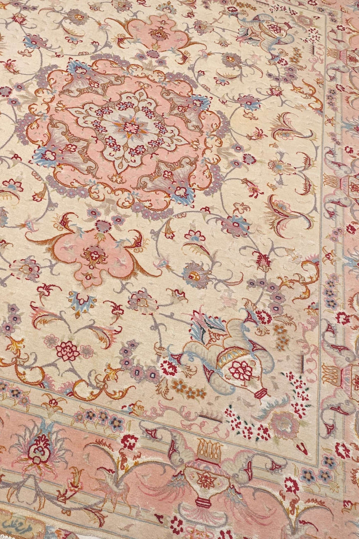 Vase border detail in cream and rose pink on Tabriz rug