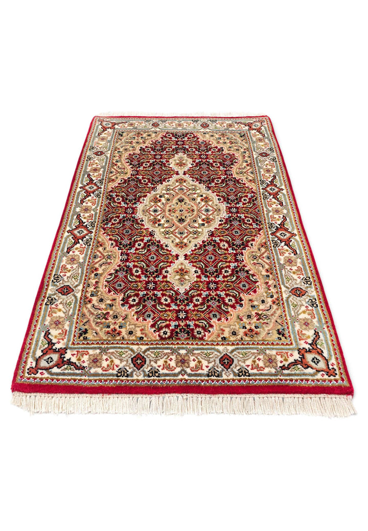 Border detail of brick red mahi Tabriz hand-knotted rug