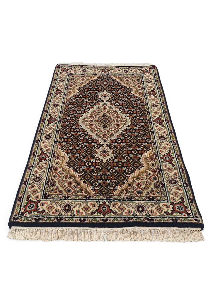 Border detail of espresso mahi Tabriz hand-knotted rug