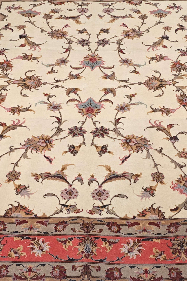 Border detail of ivory coral serrated leaf Tabriz rug