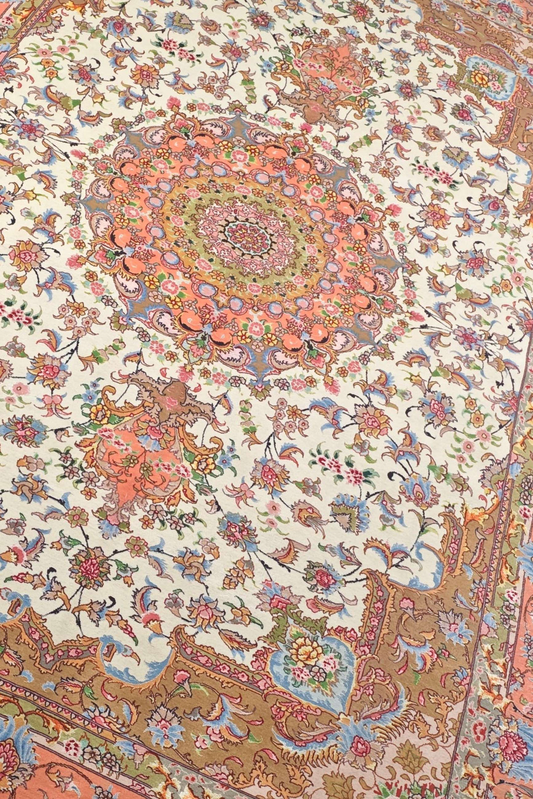 Border detail of ivory coral Tabriz hand-knotted rug