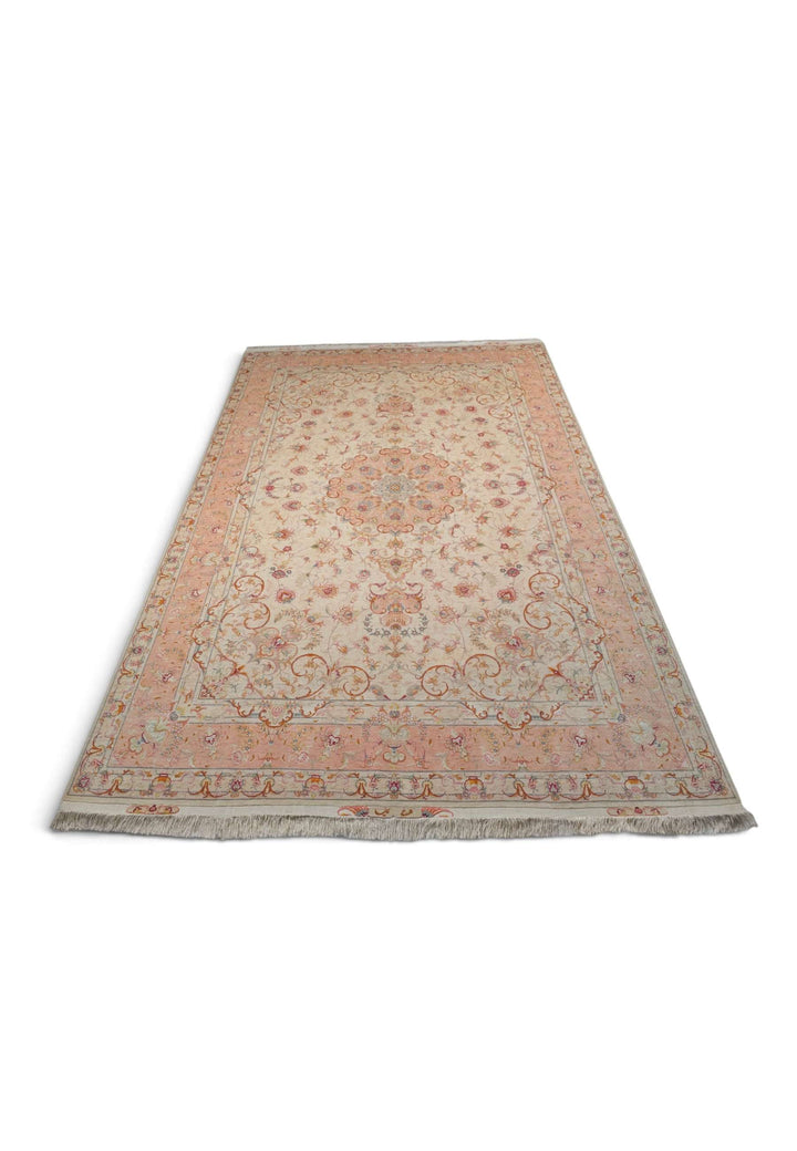 Border detail of ivory peach Tabriz hand-knotted rug
