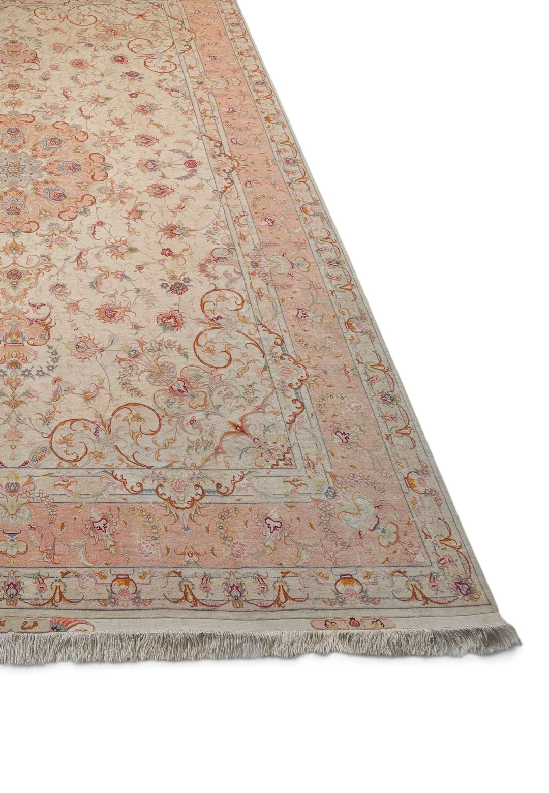 Corner of ivory peach Tabriz hand-knotted rug