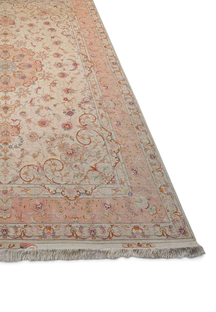 Corner of ivory peach Tabriz hand-knotted rug