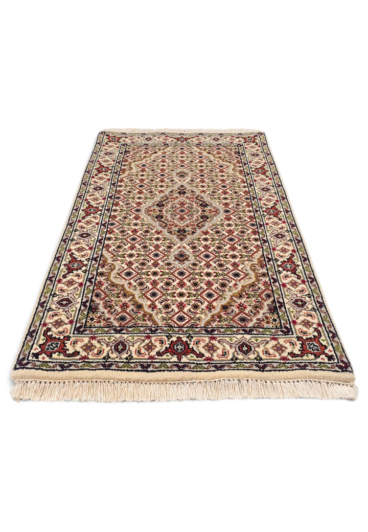 Border detail of ivory mahi Tabriz hand-knotted rug