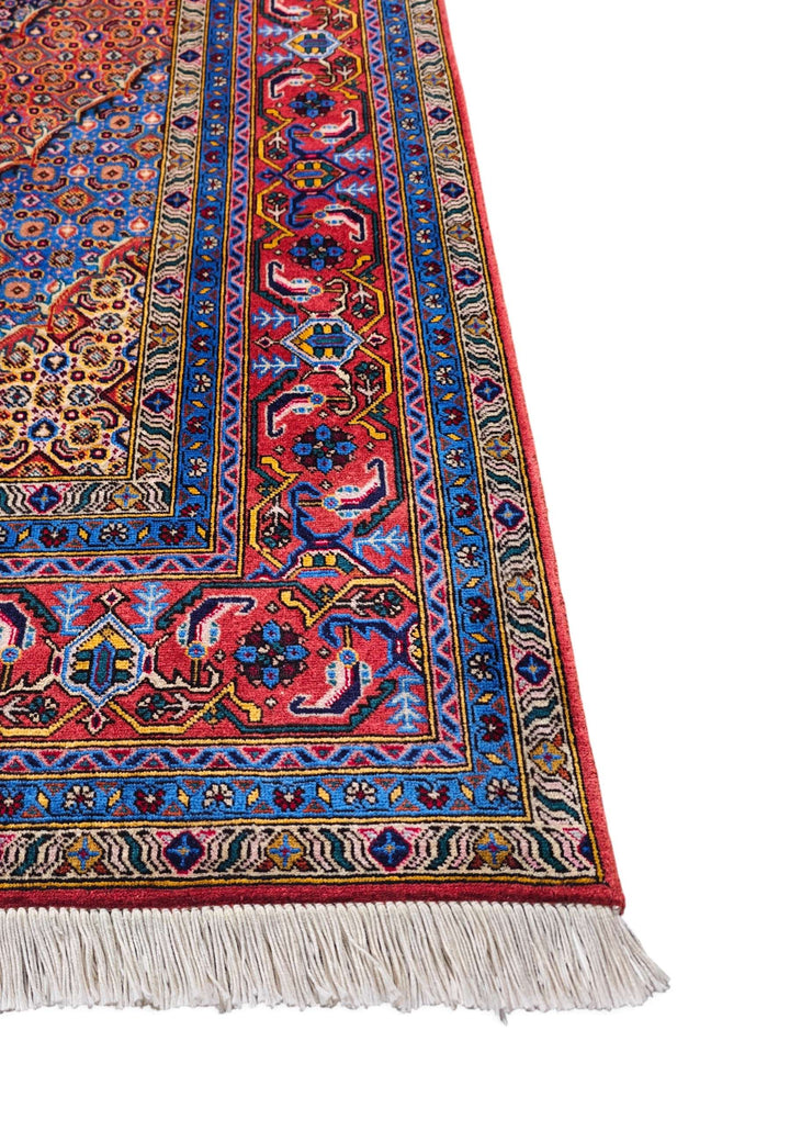 Corner of mauve and salmon Herati hand-knotted rug