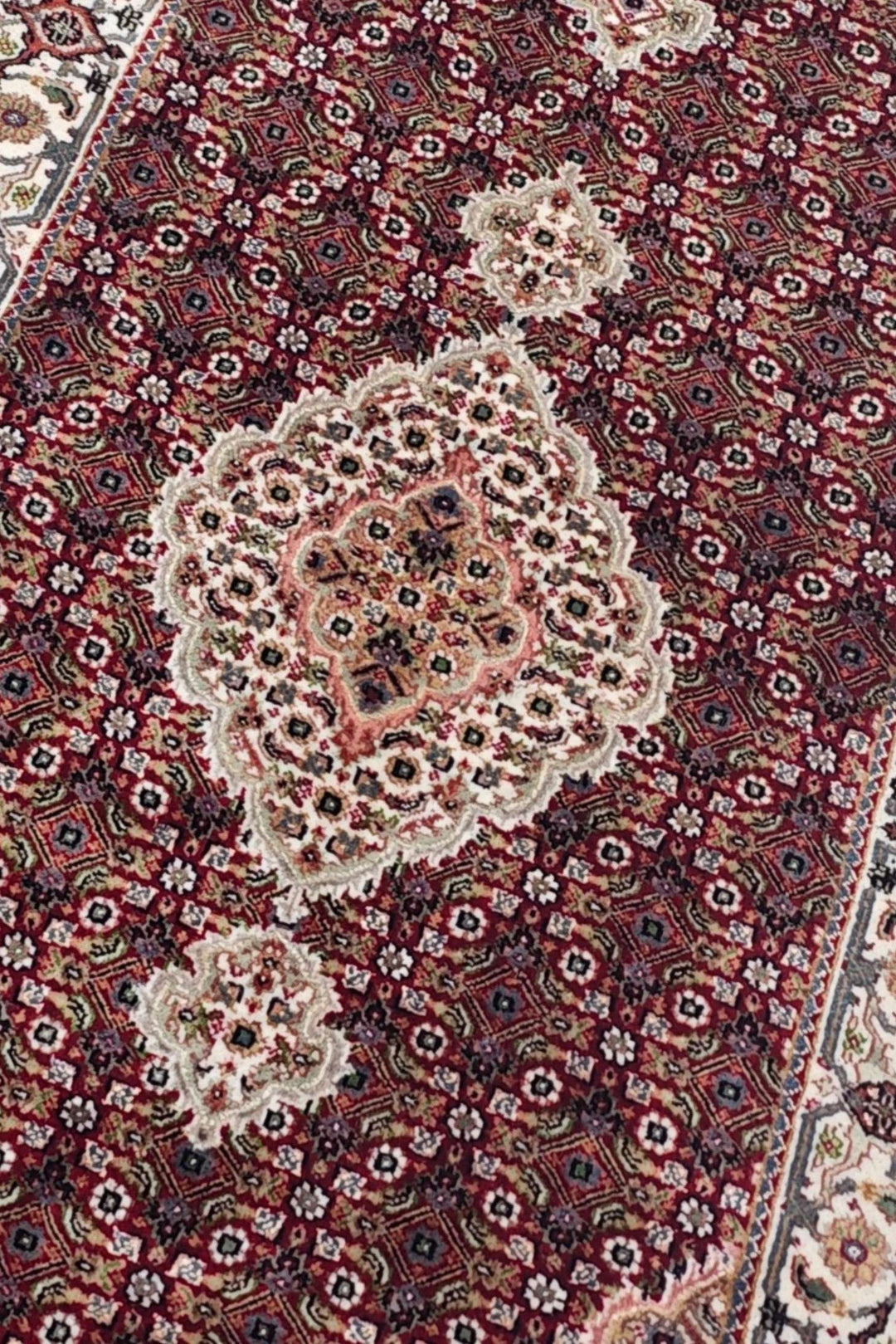 Mahi medallion detail in deep red and ivory on Tabriz runner