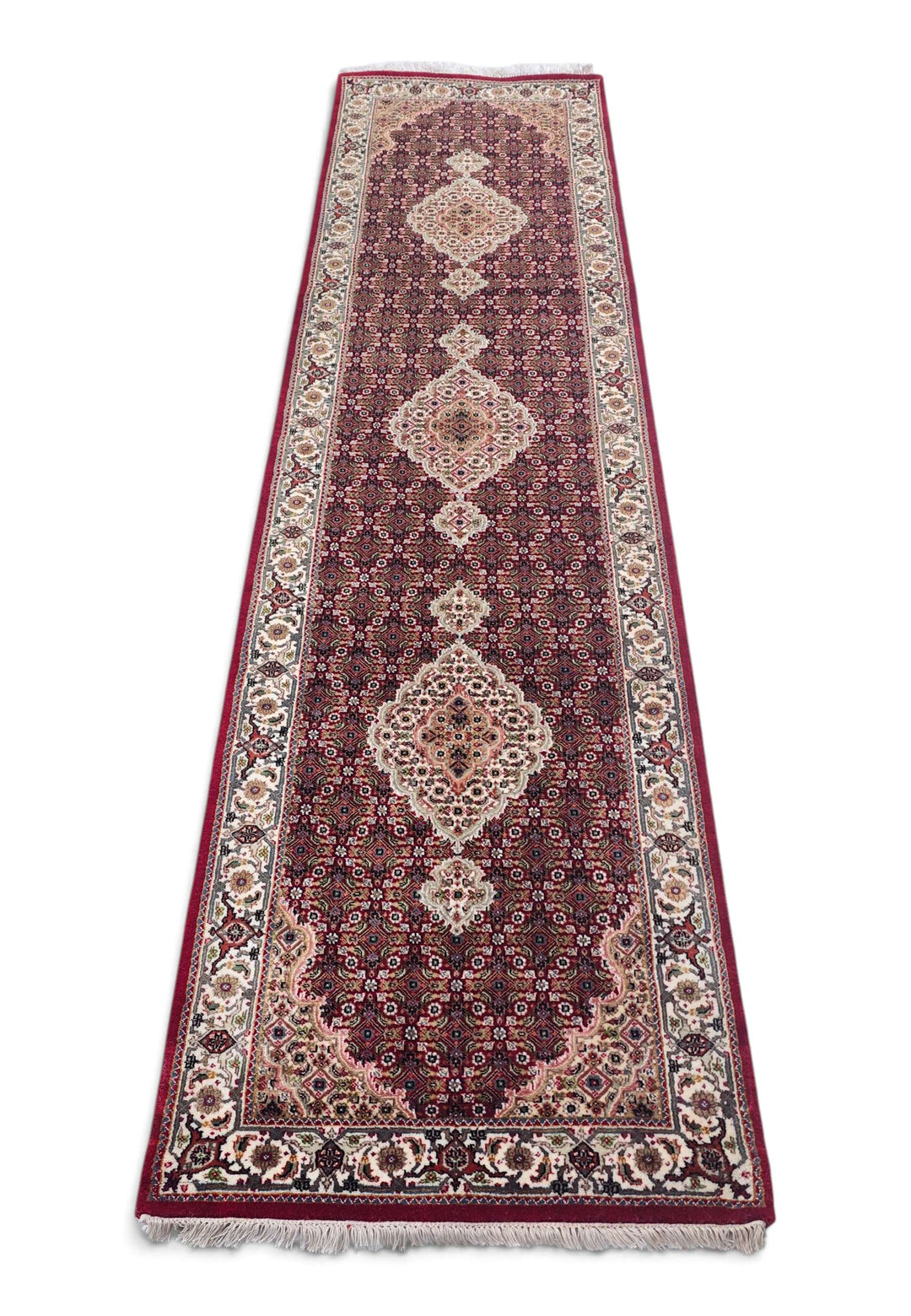Border detail of deep red Tabriz hand-knotted runner