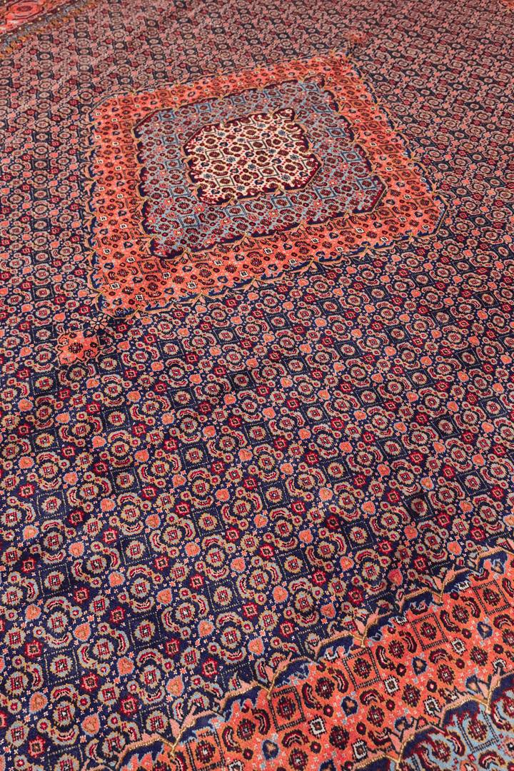 Herati medallion detail in rose and indigo on Pakistani rug