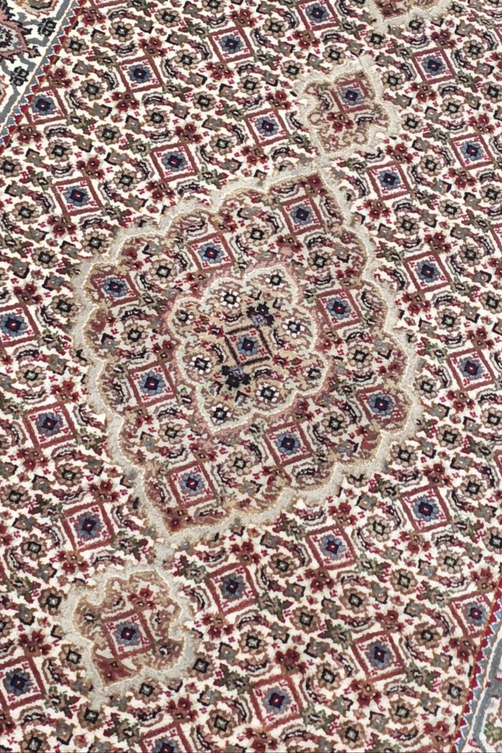Mahi medallion detail in ivory and grey on Tabriz runner