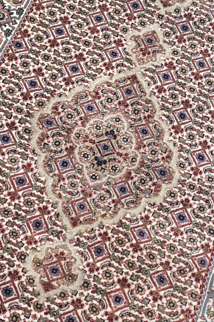 Mahi medallion detail in ivory and grey on Tabriz runner
